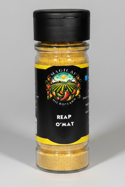 A bottle of Magic Art Reap O'Mat seasoning with a black cap and black label, showing yellow seasoning inside, on a solid white background.
