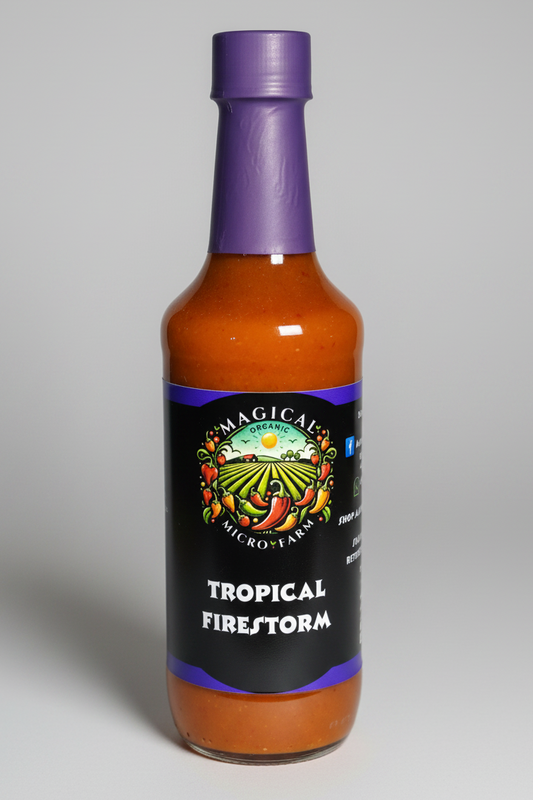A bottle of Magical Micro-Lake Tropical Firestorm hot sauce, featuring a black label with a colorful pepper farm illustration and a purple cap, set against a plain white background.