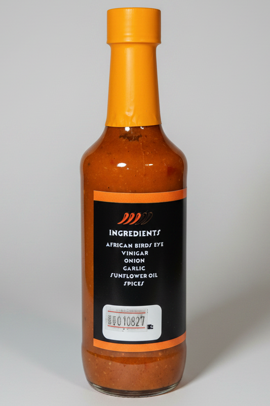 A bottle of Ingredients African Bird's Eye Vinegar Onion Garlic Sunflower Oil Spice, featuring a black label with orange accents and a bright orange cap, set against a plain white background.